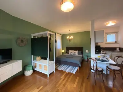a room with a bed and a table and chairs at Apartment Maximilian in Merano
