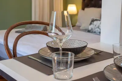 a table with two wine glasses on top of it at Apartment Maximilian in Merano