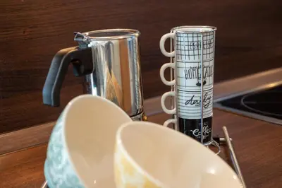 a coffee maker and a cup on a table at Apartment Maximilian in Merano
