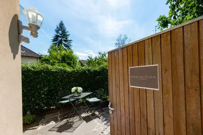 a wooden fence with a table and a sign on it at Apartment Maximilian in Merano