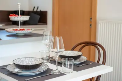 a table with plates and wine glasses on it at Apartment Maximilian in Merano