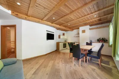 a kitchen and dining room with a wooden ceiling at Unterurban DIE ZWEI in Unsere Liebe Frau im Walde