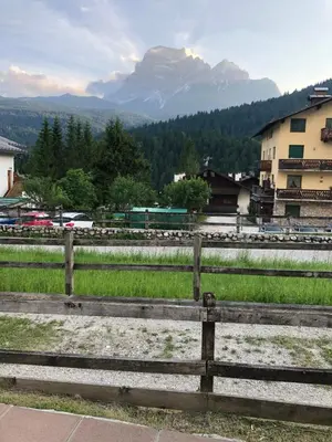 a wooden fence with a view of a mountain at Casa bianca in San Vito di Cadore
