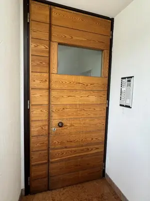 a wooden door with a mirror in a room at Casa bianca in San Vito di Cadore