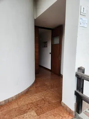 an empty hallway with a door in a building at Casa bianca in San Vito di Cadore