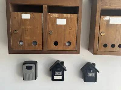 a wall with some wooden cabinets and some birds at Casa bianca in San Vito di Cadore