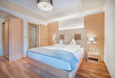 a bedroom with a large bed in a room at Hotel Ciamp in Santa Cristina in Val Gardena
