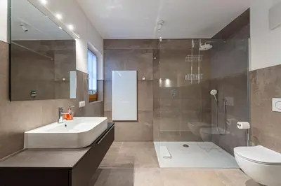 a bathroom with a sink and a toilet and a shower at Panoramic Apartment 24 in Ortisei