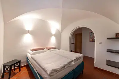 a bedroom with a large bed in a white room at Panoramic Apartment 24 in Ortisei