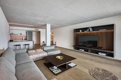 a living room with a couch and a large television at Arua Private Spa Villas in Merano