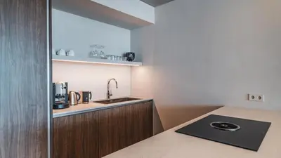a kitchen with a sink and a counter top at Arua Private Spa Villas in Merano
