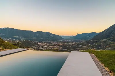 a swimming pool with a view of the mountains at Arua Private Spa Villas in Merano