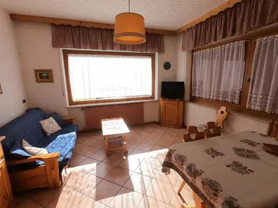 a living room with a couch and a table at ciasa de epi in Pera