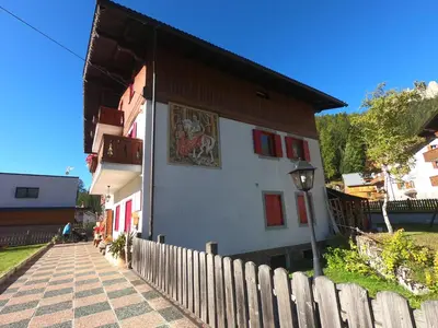 a building with a mural on the side of it at ciasa de epi in Pera