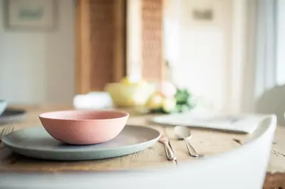 a bowl on a plate on a wooden table at Residence Belmonte in Collalbo