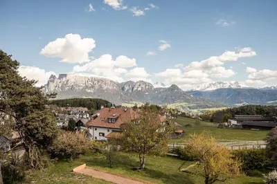 a town in a field with mountains in the background at Residence Belmonte in Collalbo
