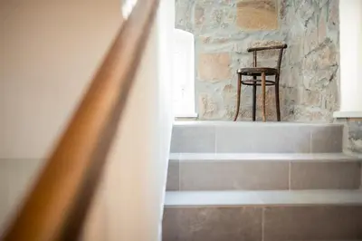 a wooden chair sitting on top of steps with a chair at Residence Belmonte in Collalbo