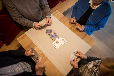 a group of people sitting around a table playing poker at Residence Belmonte in Collalbo