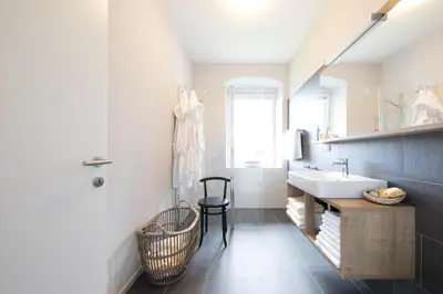 a bathroom with a sink and a desk and a sink at Residence Belmonte in Collalbo