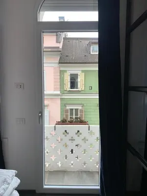 a view of a window with a view of a building at L'ECLECTIQUE Bolzano in Bolzano