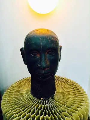 a statue of a head sitting on top at L'ECLECTIQUE Bolzano in Bolzano