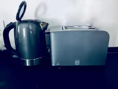 a toaster and a coffee pot sitting on a counter at L'ECLECTIQUE Bolzano in Bolzano