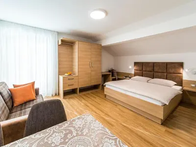 a hotel room with a bed and a couch at Apartment in Dorf Tirol near Tirol Castle in Tirolo
