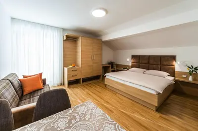 a hotel room with a bed and a couch at Apartment in Dorf Tirol near Tirol Castle in Tirolo