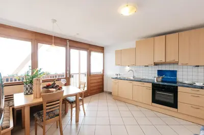 a kitchen with a table and a dining room at Bertoldihof in Cortaccia