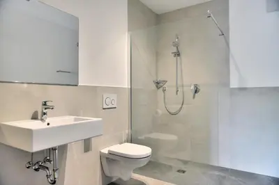 a bathroom with a sink and a toilet and a shower at Pension Georgenhof in Cermes