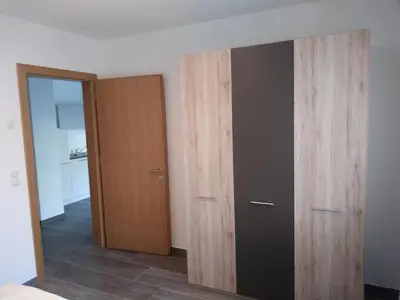 a room with two wooden cabinets and a door at Pension Georgenhof in Cermes