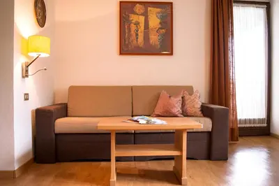 a living room with a couch and a table at Pension Georgenhof in Cermes