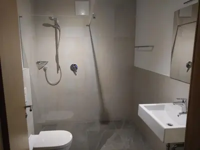 a bathroom with a shower and a toilet and a sink at Pension Georgenhof in Cermes
