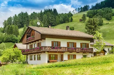 a house with a balcony on a hill at Ringlerhof in Braies