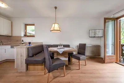 a kitchen and dining room with a table and chairs at Ringlerhof in Braies