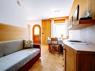 a living room with a couch and a table at Apartment Cincelli by Interhome in Pozza di Fassa