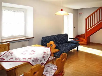 a living room with a table and a chair at Apartment Giuditta by Interhome in Pera