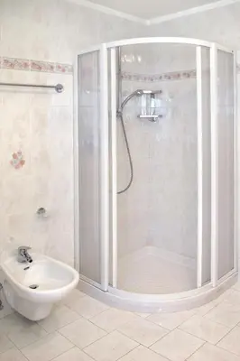 a bathroom with a shower and a toilet and a sink at Apartment Giuditta by Interhome in Pera