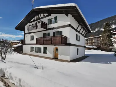 a town on a hill with mountains in the background at Apartment Cincelli - Catinaccio by Interhome in Pozza di Fassa