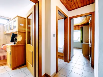 a kitchen and dining room with a table and chairs at Apartment Cincelli - Catinaccio by Interhome in Pozza di Fassa