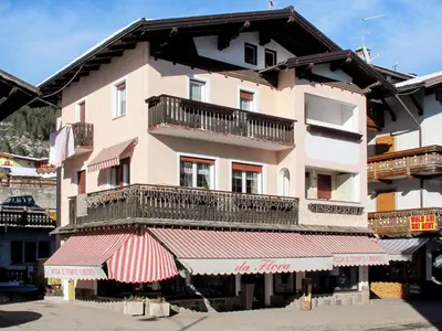 a building on the side of a street with snow at Apartment Ghetta by Interhome in Vigo di Fassa