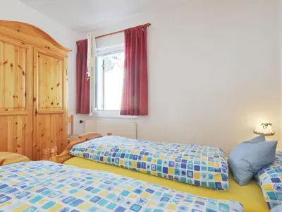a bedroom with two beds and a window at Apartment Ghetta by Interhome in Vigo di Fassa