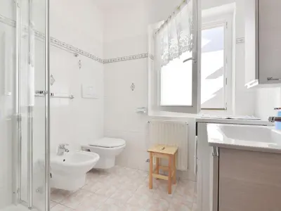 a bedroom with two beds and a mirror at Apartment Ghetta by Interhome in Vigo di Fassa