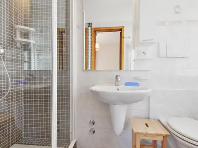 a bathroom with a tub and a sink at Apartment Ghetta by Interhome in Vigo di Fassa