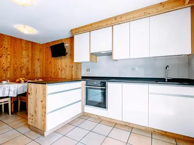 a kitchen with a table with fruit on it at Apartment Cincelli - Marmolada by Interhome in Pozza di Fassa
