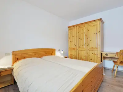 a bedroom with two beds and a desk at Apartment Bernard-1 by Interhome in Campestrin