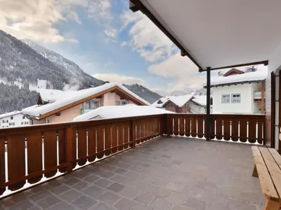 a building with wooden balconies in the mountains at Apartment Bernard-1 by Interhome in Campestrin