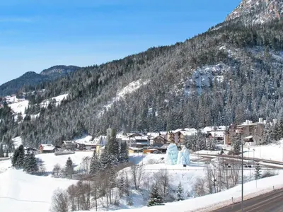a town in the snow with a mountain at Apartment Bernard-1 by Interhome in Campestrin