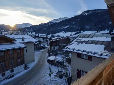 a view of a town with snow covered buildings and mountains at Apartment Casa Deluca by Interhome in Pozza di Fassa