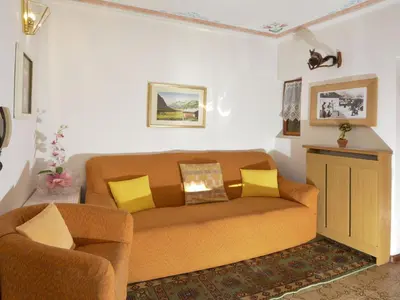 a living room with a couch and a chair at Apartment Casa Deluca by Interhome in Pozza di Fassa